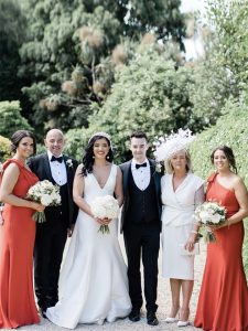Bride and groom with bridesmaids in one shoulder dress